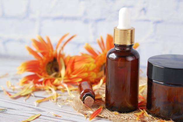 Eucalyptus essential oils in a glass bottle and flower on table