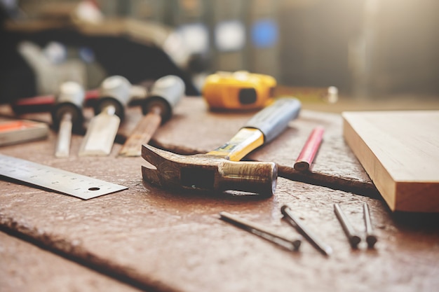 Euipment on wooden desk with workshop background.