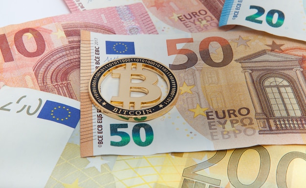 Euro banknotes and bitcoin closeup