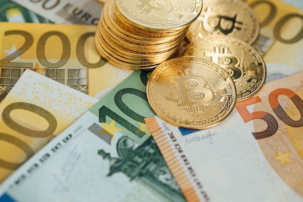 Euro Banknotes and Bitcoin cryptocurrency investing concept. Euro Money and Crypto currency golden bitcoin coin.