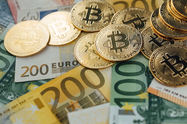 Euro Banknotes and Bitcoin cryptocurrency investing concept. Euro Money and Crypto currency golden bitcoin coin.