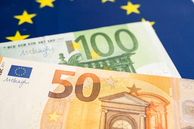 Euro banknotes on EU flag finance and accounting banking concept