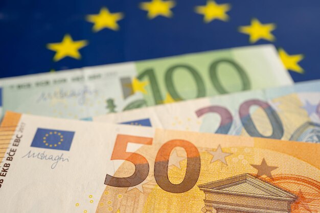 Euro banknotes on EU flag finance and accounting banking concept