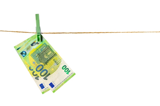 Euro banknotes hanging on a clothesline against white background Money laundering concept