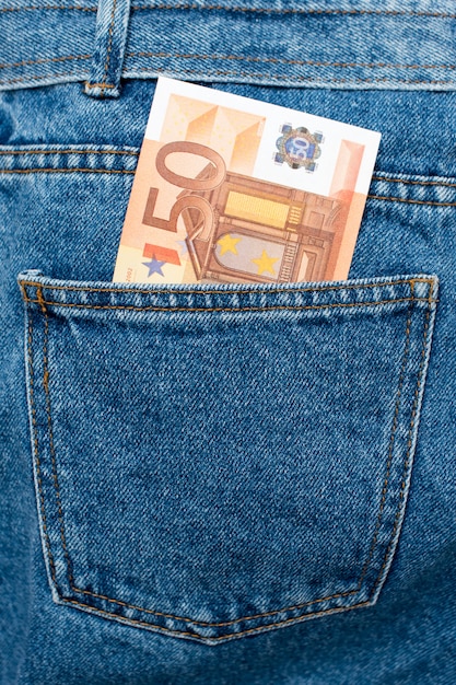Euro banknotes in jeans back pocket.