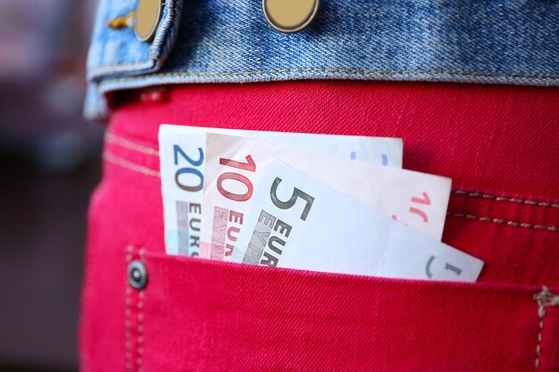 Euro banknotes in jeans pocket closeup