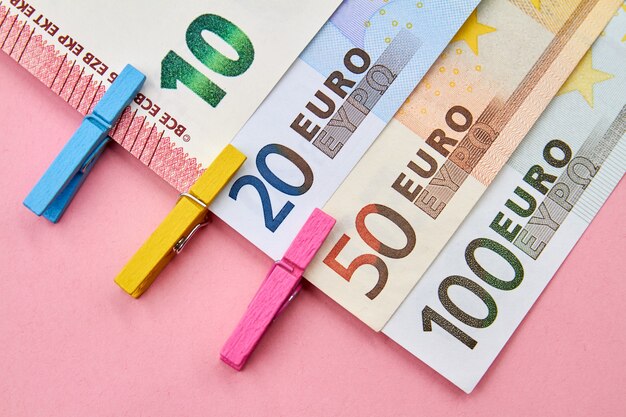 Euro banknotes with decorative clothespins