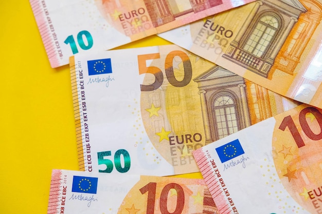 Euro banknotes on a yellow background. top view. copy, empty space for text