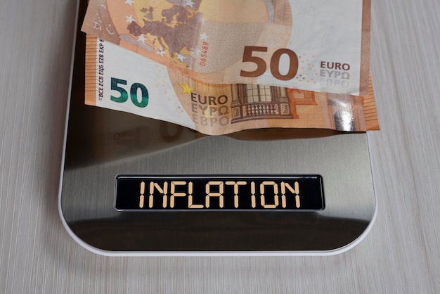 Euro bills on electronic scales a symbol of cost reduction inflation depreciation of money concept of inflation in the European Union