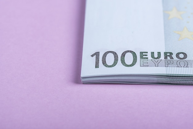 Euro cash on a lilac background