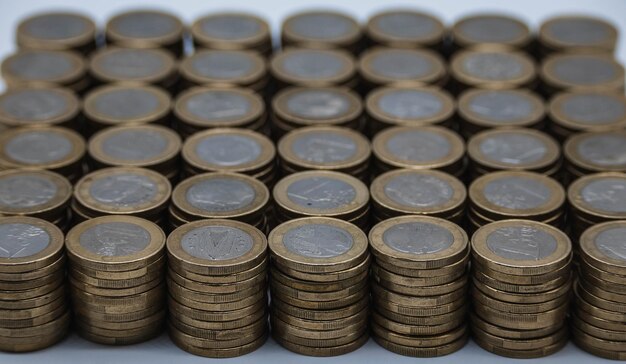 Euro coin, European currency pile.