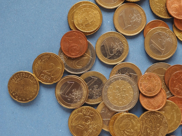 Euro coins European Union over blue with copy space