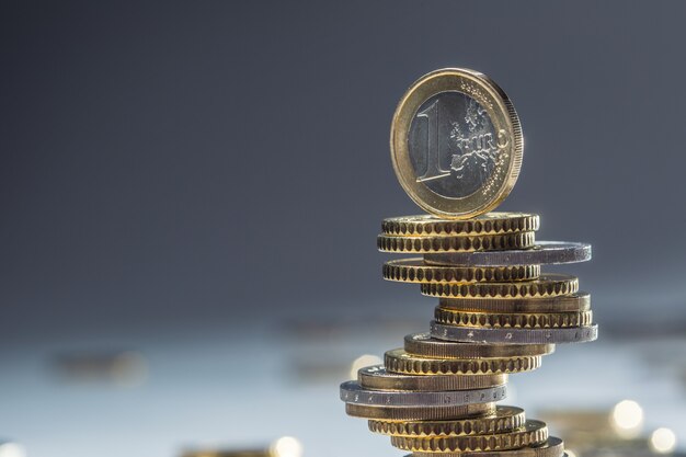 Euro coins stacked on each other in different positions. Close-up european money and currency.