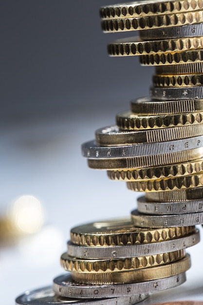 Euro coins stacked on each other in different positions. Close-up european money and currency.