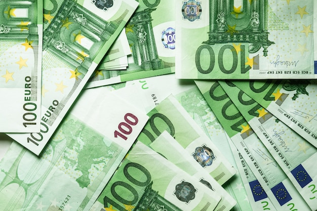 Euro currency, offers 100 euro bank note on table