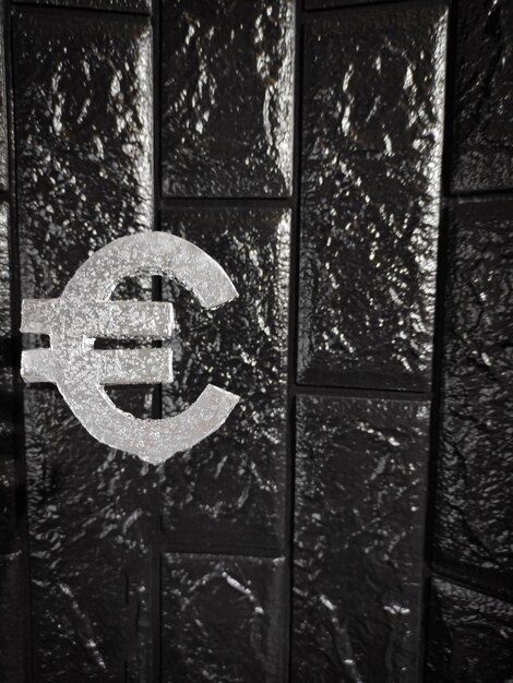 Euro currency sign Silver badge on a black background Abstraction Symbolizes business finance currency