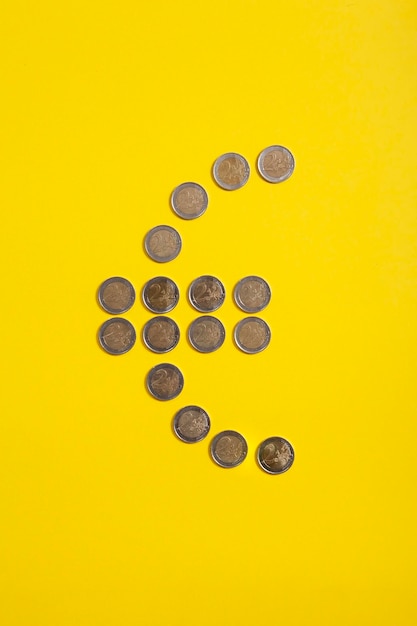 Euro symbol made from euro coins on yellow background