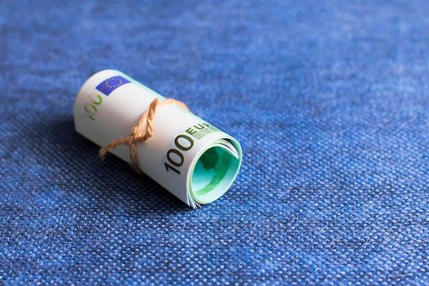 Photo eurocurrency rolls on a blue background