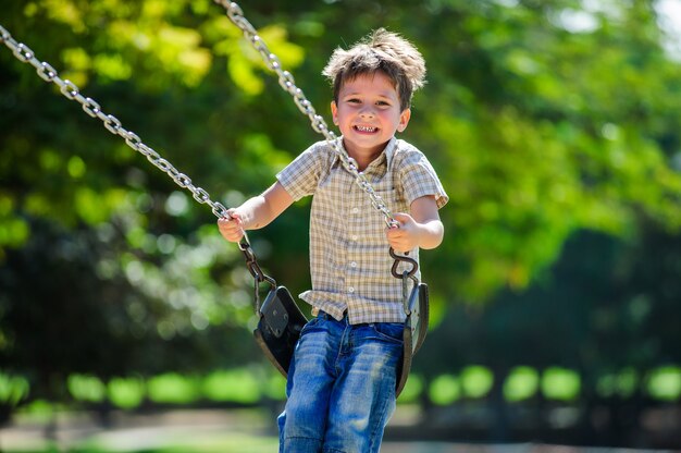 European boy on chain swing.