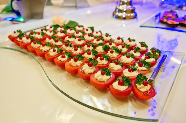 European buffet catering food Tomato halves with cream cheese Celebration party concept Selective focus