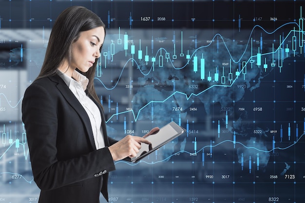 european businesswoman with tablet and creative glowing forex chart hologram