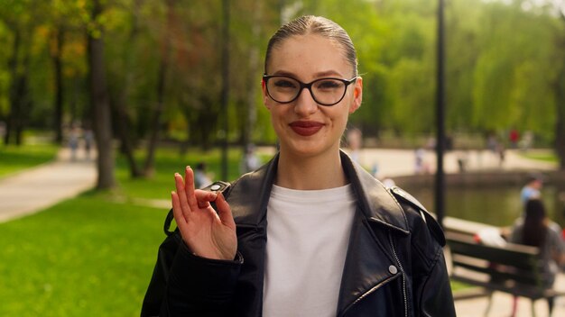 European caucasian happy woman looking at camera showing hand sign ok good glad approval smiling