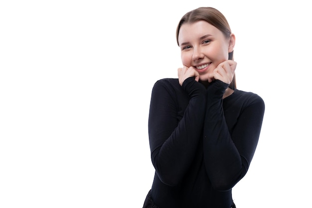 European charming schoolgirl dressed in a black blouse holds a thumbs up