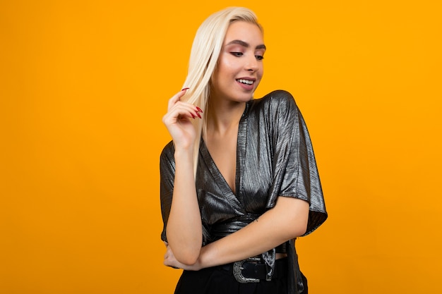 European elegant girl model posing on a yellow