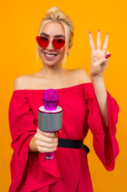 European elegant girl in a red dress with bare shoulders