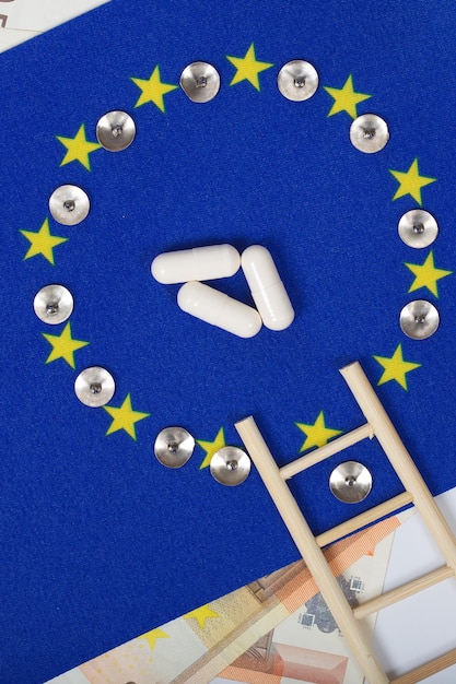 European flag,pills,ladder and european currency. Top view