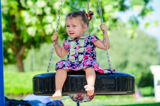 European girl on chain swing.