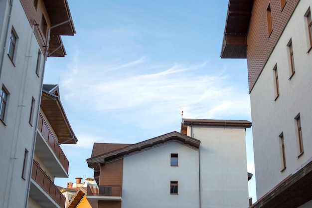 European houses with balconies opposite blue sky