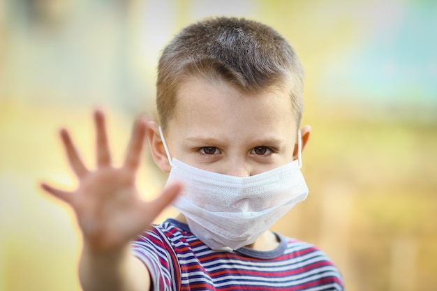 European little boy wearing mask for protect