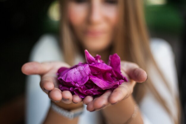 彼女の手に牡丹の花を持つヨーロッパ風少女