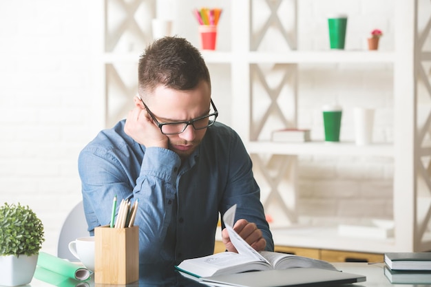 European man sleeping at workplace