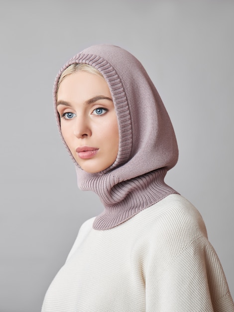 European Muslim woman with a blonde hair in a bonnet hood dressed on her head.