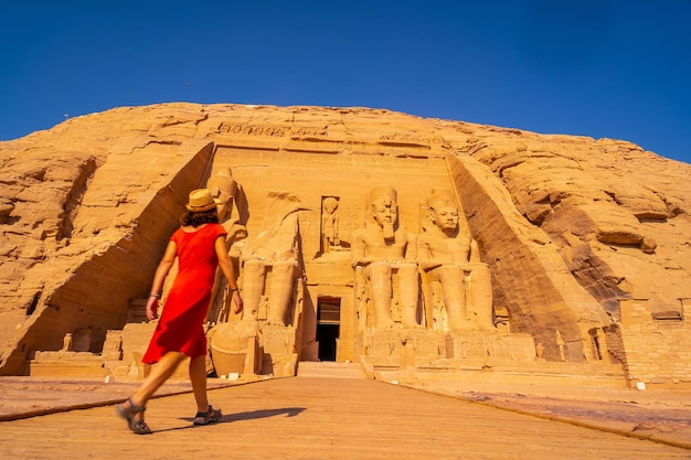 A European tourist in red dress at the Abu Simbel Temple in southern Egypt