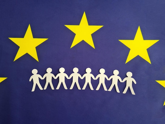 European Union citizenship concept Many paper figures holding hands stand