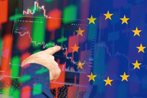 European union downtrend of the economy in a world crisis man hand shows on the decreasing candle st