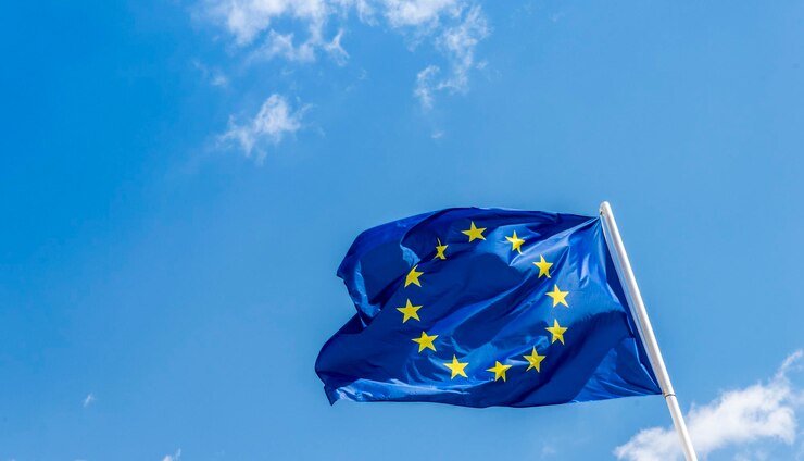 Photo european union eu flag against a blue sky soon there will be one less star since the uk voted to leave the eu in 2016