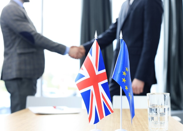 European Union and United Kingdom leaders shaking hands on a deal agreement. Brexit