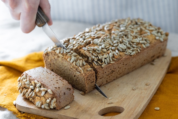 European woman baker holding buckwheat bread white woman in a light apron holding homemade sourdough