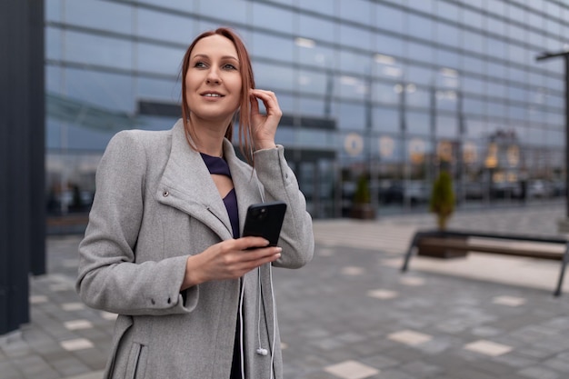 European young female administrator stands in the business center campus