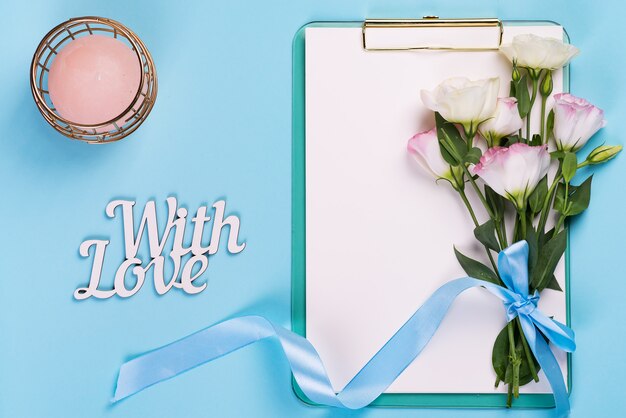 Eustoma flowers with clipboard and candle