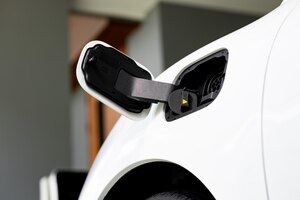 Photo ev car pluggedin with cable from progressive home charging station