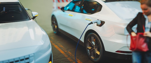 EV Electric car silhouette with low battery charging at electric charge station