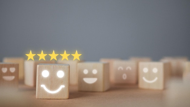 Evaluation and satisfaction concept five stars and smile emojis\
show an excellent job close up shot on wood block with copy space\
there some noise and gain