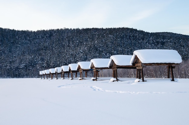 自然の中でピクニックのための家の均一な列すべてが雪で覆われています