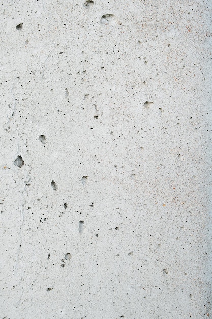 Even smooth grey concrete texture riddled with holes from
escaping gases