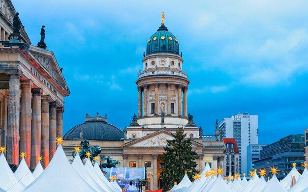 Evening Christmas market of Gendarmenmarkt in Berlin in Germany Europe winter. German Night street Xmas and holiday fair in European city. Advent Decoration and Stalls with Crafts Items on Bazaar